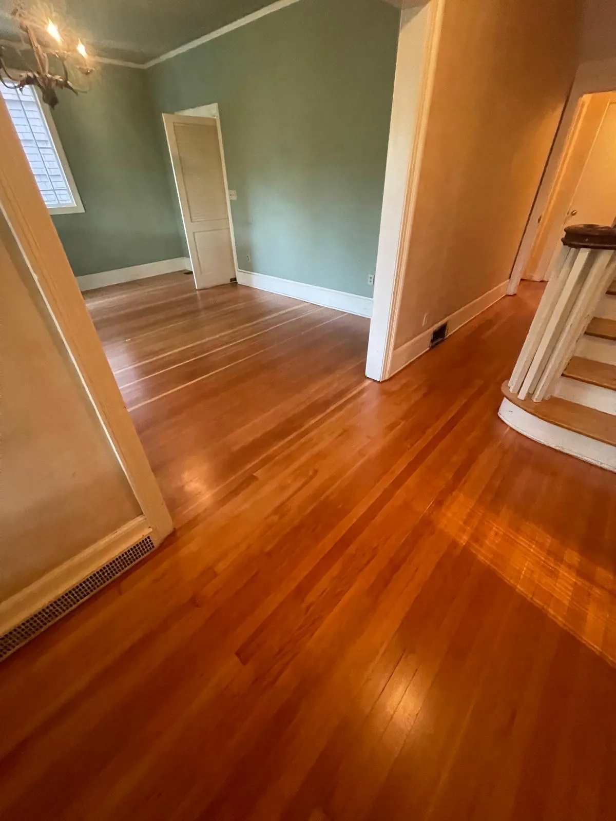 Old, gray, dull hardwood floor with worn finish before restoration